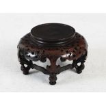 A Chinese dark wood and silver wire inlaid circular stand, raised on four ruyi and foliate scroll