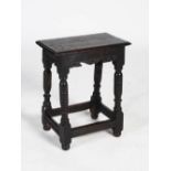 An antique oak joynt stool, the later rectangular planked top raised on four turned supports
