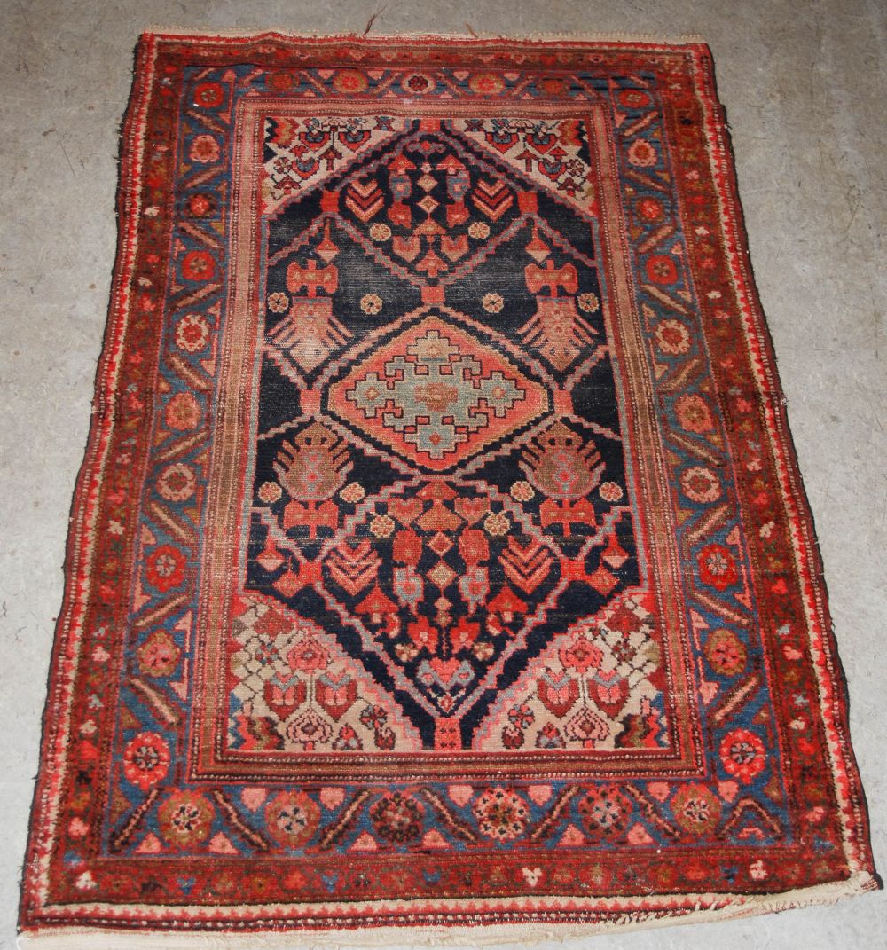 A blue ground Eastern rug, 20th century, the rectangular field centred with a lozenge shaped