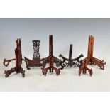 A collection of assorted carved and pierced wood plate stands, 19th century and later, comprising;