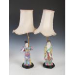 A pair of Chinese porcelain figural table lamps, 20th century, one modelled with a scholar, the