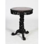 A Chinese dark wood table, Qing Dynasty, the circular top with a mottled red and white marble insert