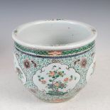 A Chinese porcelain famille verte jardiniere, Qing Dynasty, decorated with shaped oval panels of