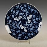 A Japanese blue and white porcelain charger, late 19th/early 20th century, decorated with prunus