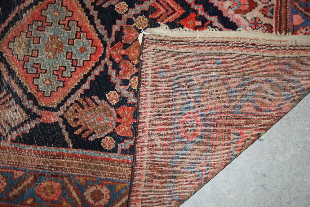 A blue ground Eastern rug, 20th century, the rectangular field centred with a lozenge shaped - Image 2 of 4