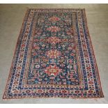 A blue ground Persian rug, early 20th century, the rectangular field centred with a row of five