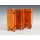 A Chinese carved and painted wood six panel miniature table screen, each panel decorated with