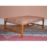 A George III style mahogany rectangular shaped stool, the stuffover upholstered top raised on four