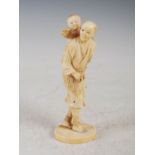 A Japanese ivory okimono of father and son, Meiji Period, signed, 16.5cm high.