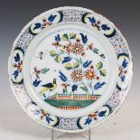 An 18th century Delft charger, decorated in the Fazakerley palette with a fenced garden of flowers