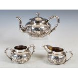 A Chinese silver three piece tea set, makers mark of SF, late 19th/ early 20th century, with