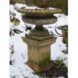 A 19th century fire clay garden urn on plinth, 124cm high x 88cm diameter.