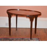 A George III style mahogany tray top occasional table, the oval top raised on four tapered