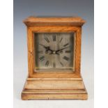 A late 19th/ early 20th century rosewood mantle clock, the silvered dial with Roman numerals and