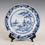 A Chinese porcelain blue and white plate, Qing Dynasty, decorated with pine tree, figure and