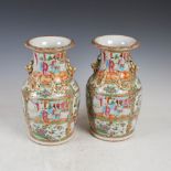 A pair of Chinese porcelain famille rose Canton vases, Qing Dynasty, decorated with panels of