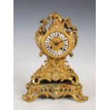 A late 19th/early 20th century French ormolu Rococo style mantel clock, the circular dial with