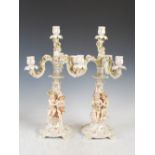 A pair of late 19th century Continental porcelain four light candelabra, formed in two sections with