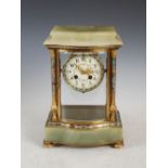 An early 20th century onyx, gilt metal and champleve enamel mantel clock, the circular dial with