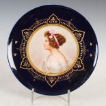 A Vienna porcelain cobalt blue ground cabinet plate titled 'LIEBESERWACHEN', signed J. Dahn, blue