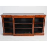 A William IV rosewood breakfront open bookcase, the shaped rectangular top above a plain frieze