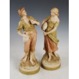 A pair of Royal Dux porcelain figures modelled as male and female water carriers, applied and