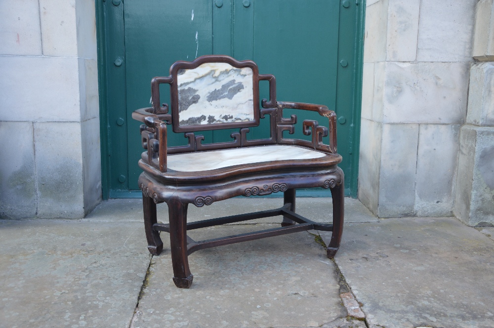 A Chinese dark wood and marble armchair, Qing Dynasty, the rectangular panelled back with grey and