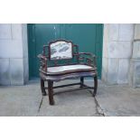 A Chinese dark wood and marble armchair, Qing Dynasty, the rectangular panelled back with grey and