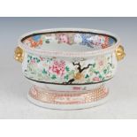 A Chinese porcelain famille rose wine cooler, Qing Dynasty, decorated with peony, with two shi shi