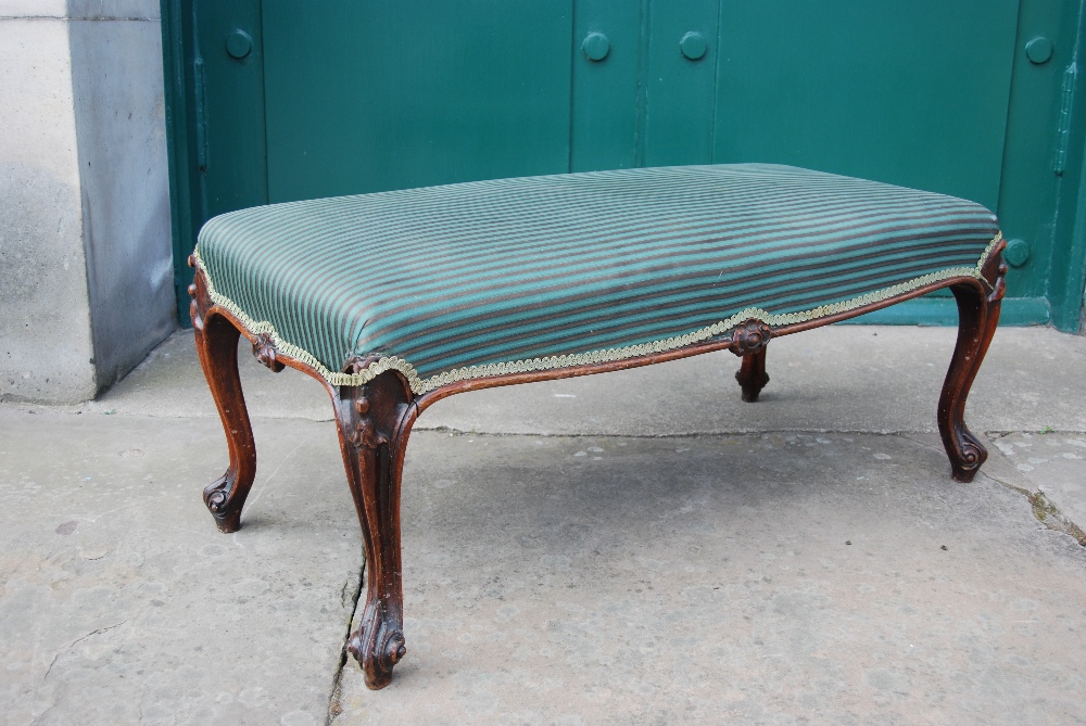 A Victorian mahogany stool, the green striped upholstered seat raised on four scroll