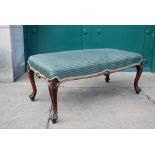 A Victorian mahogany stool, the green striped upholstered seat raised on four scroll