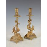 A pair of 19th century ormolu candlesticks of Nautical interest, the nozzles with pierced decoration