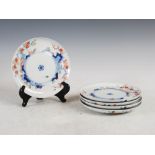 A set of five Japanese Kakiemon plates, Meiji Period, with asymmetric decoration of prunus and