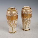 A pair of Japanese Satsuma pottery vases, Meiji Period, decorated with flowering branches and