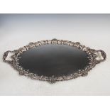 A mid 20th silver twin handled serving tray, Sheffield, 1975, makers mark of R&B, oval shaped with