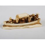 A Japanese ivory okimono of family group in a boat, Meiji Period, signed, 6cm long x 2cm high.