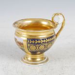 A late 19th/early 20th century Paris porcelain cobalt blue ground chocolate cup, decorated with a