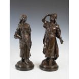 A pair of bronzed Arabian figures, modelled with a male figure, his right hand raised to his brow,