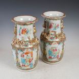 A pair of Chinese porcelain famille rose Canton vases, Qing Dynasty, decorated with panels of