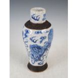 A Chinese porcelain crackle glazed blue and white jar, Qing Dynasty, decorated with shi shi dogs