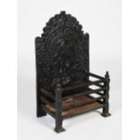A 19th century cast iron fire basket, the rectangular panelled back cast in relief with a figure,