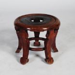 A Chinese carved wood jardiniere stand, the dished circular top pierced with a circular cut out,