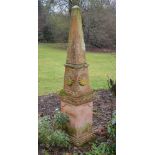 A pair of terracotta garden obelisks, formed in two sections, the upper triangular section resting