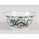 A Chinese porcelain wucai dragon bowl, Qianlong seal mark and of the period, decorated with