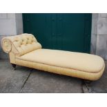 A Victorian mahogany chaise longue, the button down upholstered back and stuffover seat raised on