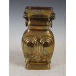 A Chinese gilt bronze rectangular shaped vase, Qing Dynasty, cast with four oval shaped panels,