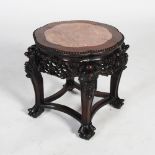 A Chinese dark wood jardiniere stand, late Qing Dynasty, the shaped circular top with a mottled