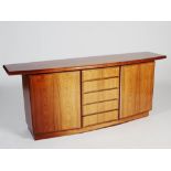 A 1970's Danish Rasmus rosewood sideboard, the shaped rectangular top above five central drawers