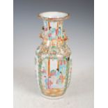 A Chinese porcelain famille rose Canton vase, Qing Dynasty, decorated with panels of figures divided