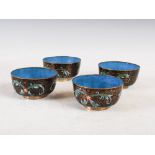 Four Chinese black ground cloisonne bowls, late 19th/early 20th century, decorated with stylised